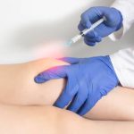 The doctor injects an ozone-oxygen mixture into the patient's knee joint to relieve muscle spasm and inflammation. Ozone therapy, copy space for text, treatment